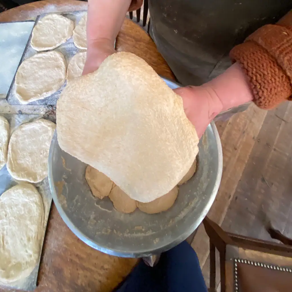off grid homesteader kate downham shaping whole grain fresh milled sourdough pizza dough
